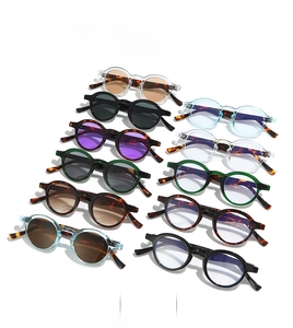 Detailed array of vintage small frame sunglasses in multiple lens and frame color options