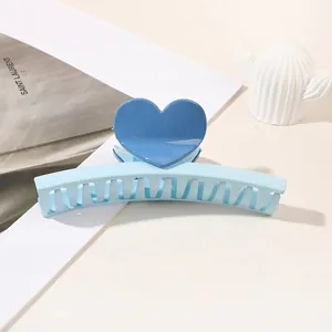 Detailed macro shot of a sweet blue heart hair claw clip for elegant hairstyles