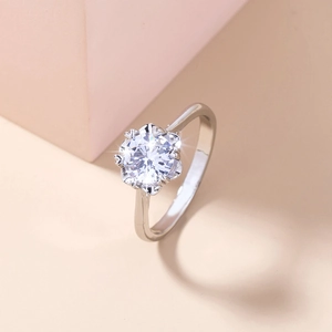 Macro detail of silver ring with round zircon in a unique six-prong petal setting