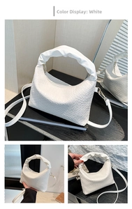 Detail of white woven leather bucket bag featuring a unique ruched cloud handle design