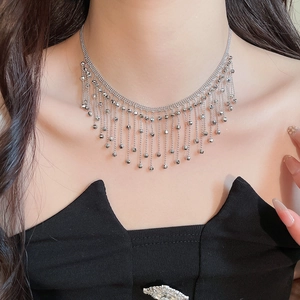 Close-up of multi-layer silver fringe necklace on neck showing metallic luster
