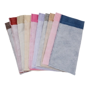 Linen drawstring wine gift bags in various colors shown in a fan-shaped arrangement