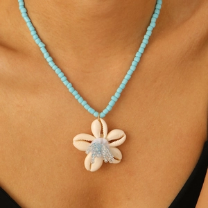 Bohemian anklet with sky blue beads and natural white shell flower pendant on model