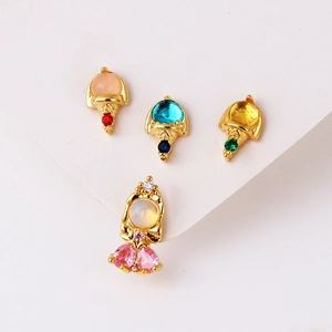 Close-up of gold stud earrings set with colorful pink, blue, yellow, and red zircons