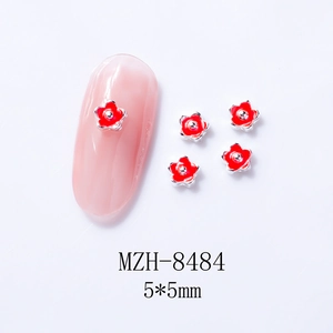 Detailed 5x5mm red five-petal flower nail charms with silver base on nude pink nails