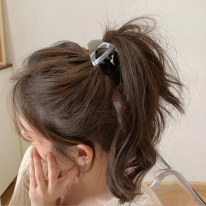 Elegant high ponytail claw clip in grey marble finish shown on a woman's hair