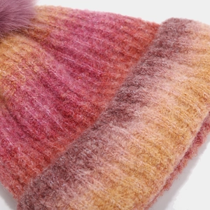 Close-up of thick ribbed knit mohair texture and warm gradient colors of the winter hat
