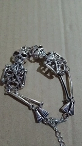 Detail of Gothic skull bracelet with adjustable lobster clasp and skeletal metal joints