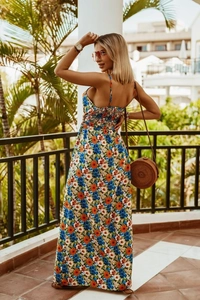 Detail of bohemian floral maxi dress with blue and orange prints and spaghetti straps