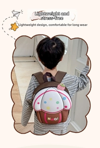 Kids cupcake shaped backpack featuring strawberry charm and NMQI logo on back