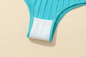 Macro detail of breathable double-layer cotton crotch lining on ribbed blue panties