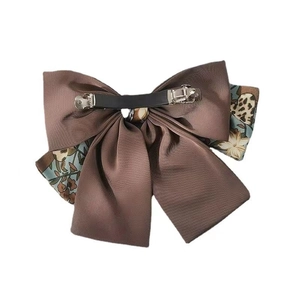 Vintage double-layered bow hair clip with floral patterns and a metal spring fastener