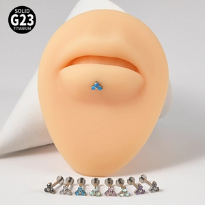 Detailed display of G23 titanium labret studs with various colors of opal and zircon stones