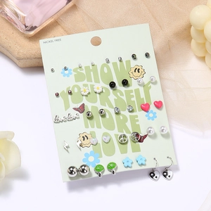 Detail of 20 pairs alloy earring set with daisy and heart motifs on display card