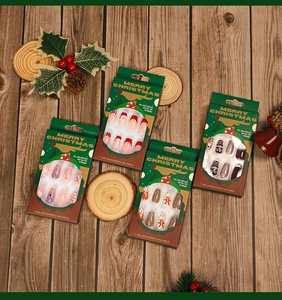 Detailed view of Christmas press-on nail sets featuring snowflake and ginger man designs