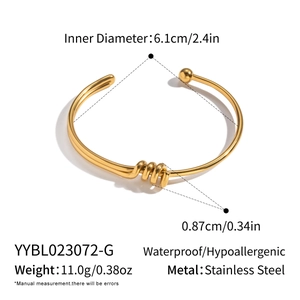 Detail view of gold twisted cuff bracelet with inner diameter 6.1cm and 11g weight specs