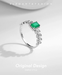 Macro shot of S925 silver ring featuring emerald-cut green stone and leaf-shaped diamond sides