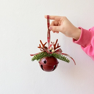 Deep red Christmas metal bell with reindeer antlers and red check ribbon hanger