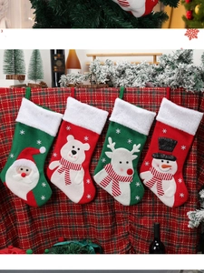 Detail of four Christmas stockings with Santa, reindeer, bear, and snowman motifs