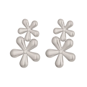 Close-up of silver double-layered floral stud earrings with high-polish mirror finish