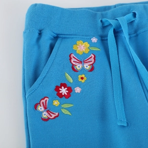 Girls royal blue sports joggers with elastic ribbed waist and floral butterfly embroidery