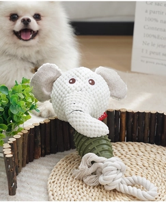 Detail of plush elephant dog toy with textured rubber ring and cotton rope for chewing