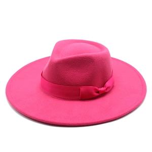Close-up of fuchsia wool felt fedora hat featuring a wide brim and grosgrain ribbon bow