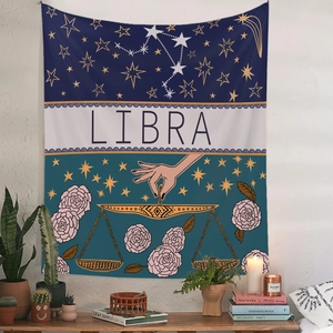 Detail of Libra zodiac tapestry featuring celestial patterns and floral designs on wall