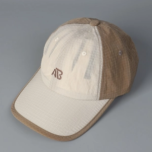 Detail of checkered quick-dry fabric and embroidered AB logo on two-tone baseball cap