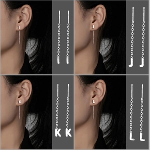 Close-up of S999 sterling silver letter tassels showing delicate threader earring details