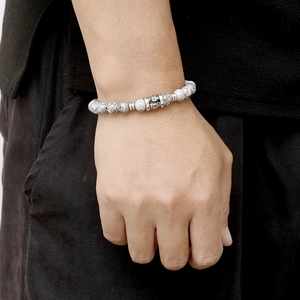 Men's 8mm natural stone beaded bracelet featuring grey lava stones and a silver skull charm