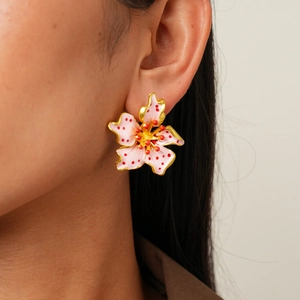 Pink enamel flower stud earrings with gold trim and red dots for a stylish spring look
