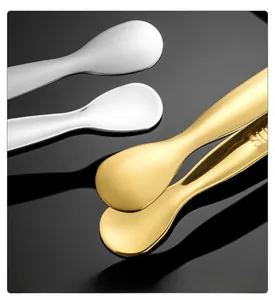 Close-up of golden and silver stainless steel spoons with SUS engraving and brushed finish
