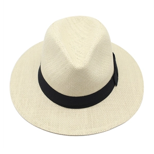 Top view of beige straw Panama hat featuring a black decorative band and fine woven texture
