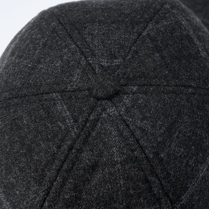 Macro detail of the six-panel crown structure and stitching on a wool men's winter cap