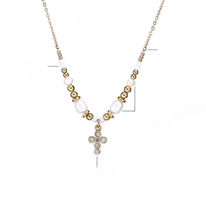 Detail of cross pendant necklace with freshwater pearls and sparkling crystal inlay