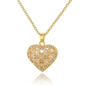 Detailed close-up of a golden heart-shaped zircon pendant with a grid pattern texture