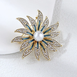 Detailed macro view of sunflower brooch with white crystals, blue enamel and a large pearl