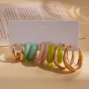 Detail view of 5-pair acrylic resin hoop earring set in mint green and gold finish