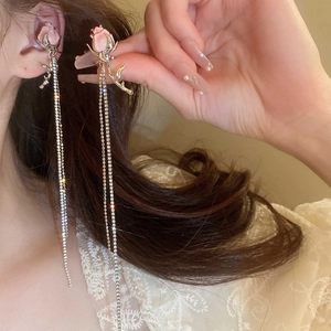 Detail of pink rose stud earring with cascading silver rhinestone fringe tassels on model