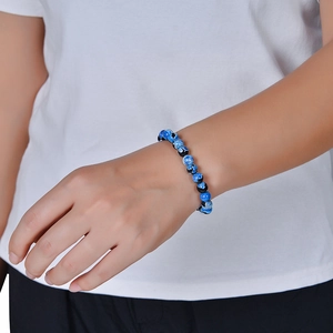 Blauw en zwart agaat kralenarmband met natuursteen textuur op de pols van een vrouw