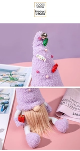 Close-up of purple Christmas gnome with candy hat, brown beard and red gift box detail