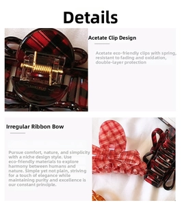 Close-up of red plaid acetate hair claw clip showing bow design and metal spring detail