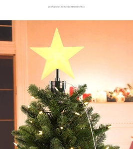 Close-up of glowing yellow LED Christmas tree star topper with warm festive light