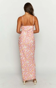 Back view of a white floral maxi dress with thin straps and open back lace-up detail