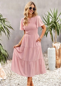 Detail of pink tiered maxi dress featuring smocked bodice and fluttering ruffle sleeves