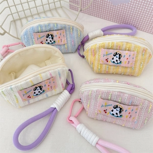 Detailed view of macaron color tweed mini bags with cute puppy patches and metal hooks