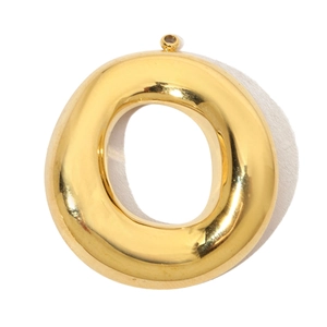 Macro shot of polished gold-toned stainless steel round pendant with top ring