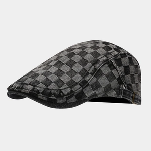 Detail of vintage checkerboard denim flat cap with adjustable bronze side buckle