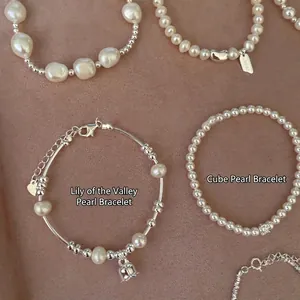 Elegant Korean style pearl and silver bead bracelets set on a pink velvet background
